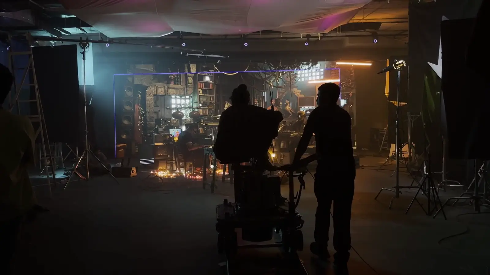Crew in silhouette on a dark film set